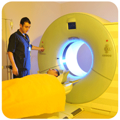 photo of technologist positioning a patient in an MRI scanner