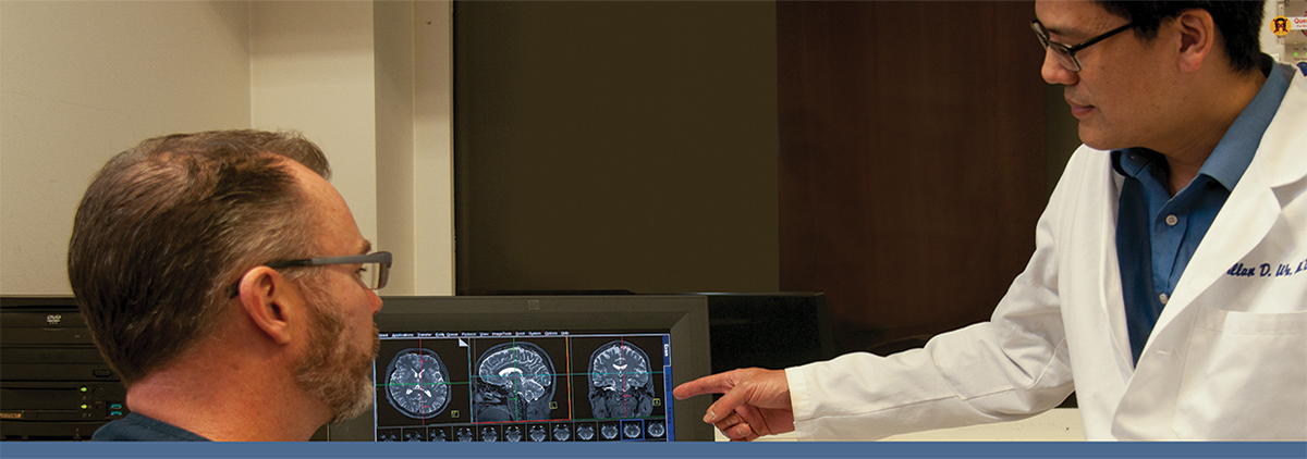 Researcher and technologist reviewing data at MR scanner console