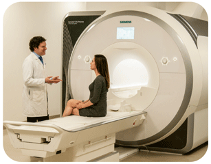 Photo of woman sitting on scanner bed with researcher