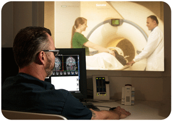 Researchers and participant in Sonata scanner viewed from control room